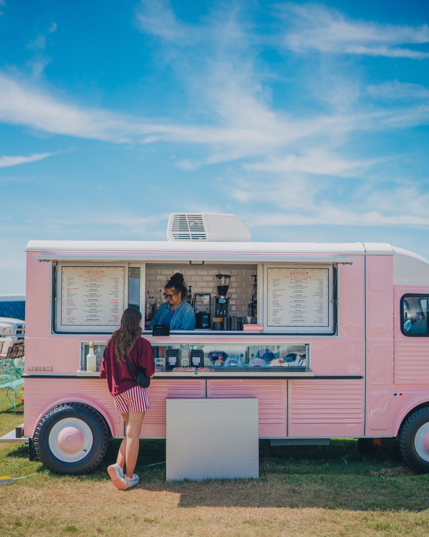 The Maple and Honey pink coffee trailer serving guests